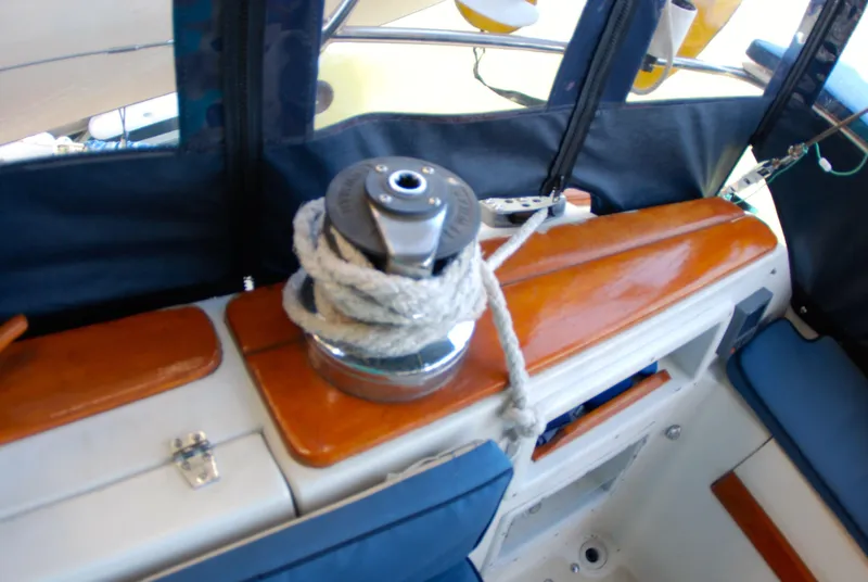 Slide: The Image of Winch with rope on 1985 Endeavour 38 sailboat, featuring wooden and blue interior elements. - 27