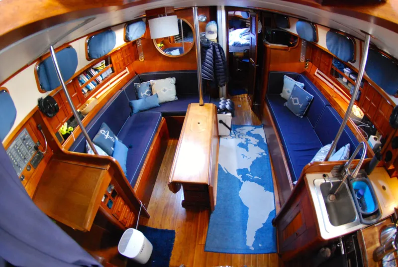 Slide: The Image of Interior of 1985 Endeavour 38 sailboat with cozy seating and nautical decor. - 28