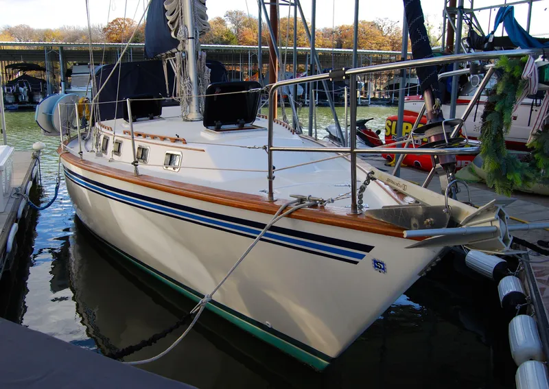 Slide: The Image of 1985 Endeavour 38 sailboat docked at marina, featuring sleek design and blue accents. - 3