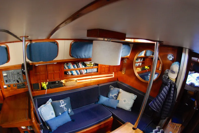 Slide: The Image of Interior of 1985 Endeavour 38 sailboat with cozy seating, nautical decor, and wooden finishes. - 30