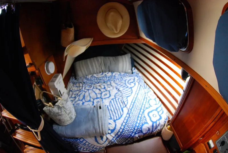 Slide: The Image of Cozy cabin interior of 1985 Endeavour 38 sailboat with nautical decor and bedding. - 33