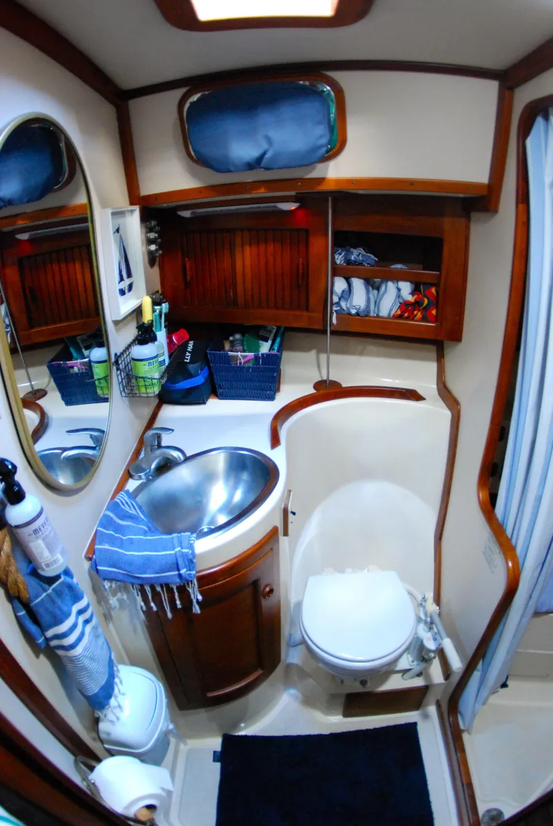 Slide: The Image of Compact bathroom in 1985 Endeavour 38 sailboat with sink, toilet, and storage. - 35