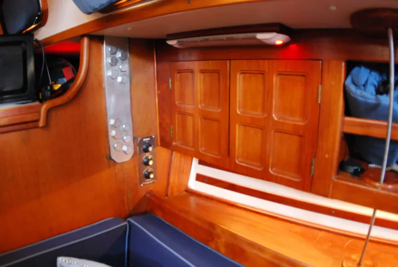 Slide: The Image of Interior of 1985 Endeavour 38 sailboat with wooden cabinetry and seating area. - 41