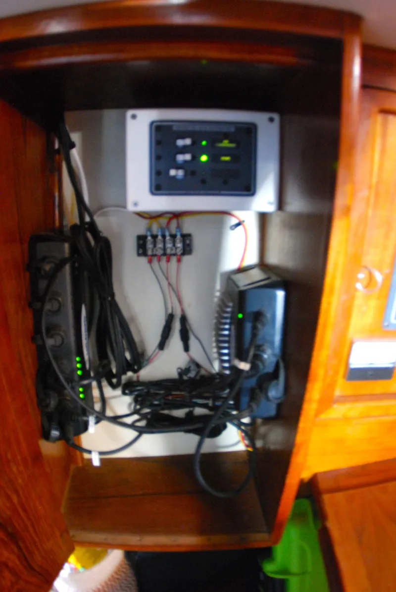 Slide: The Image of Electrical panel and wiring inside a 1985 Endeavour 38 sailboat cabinet. - 43