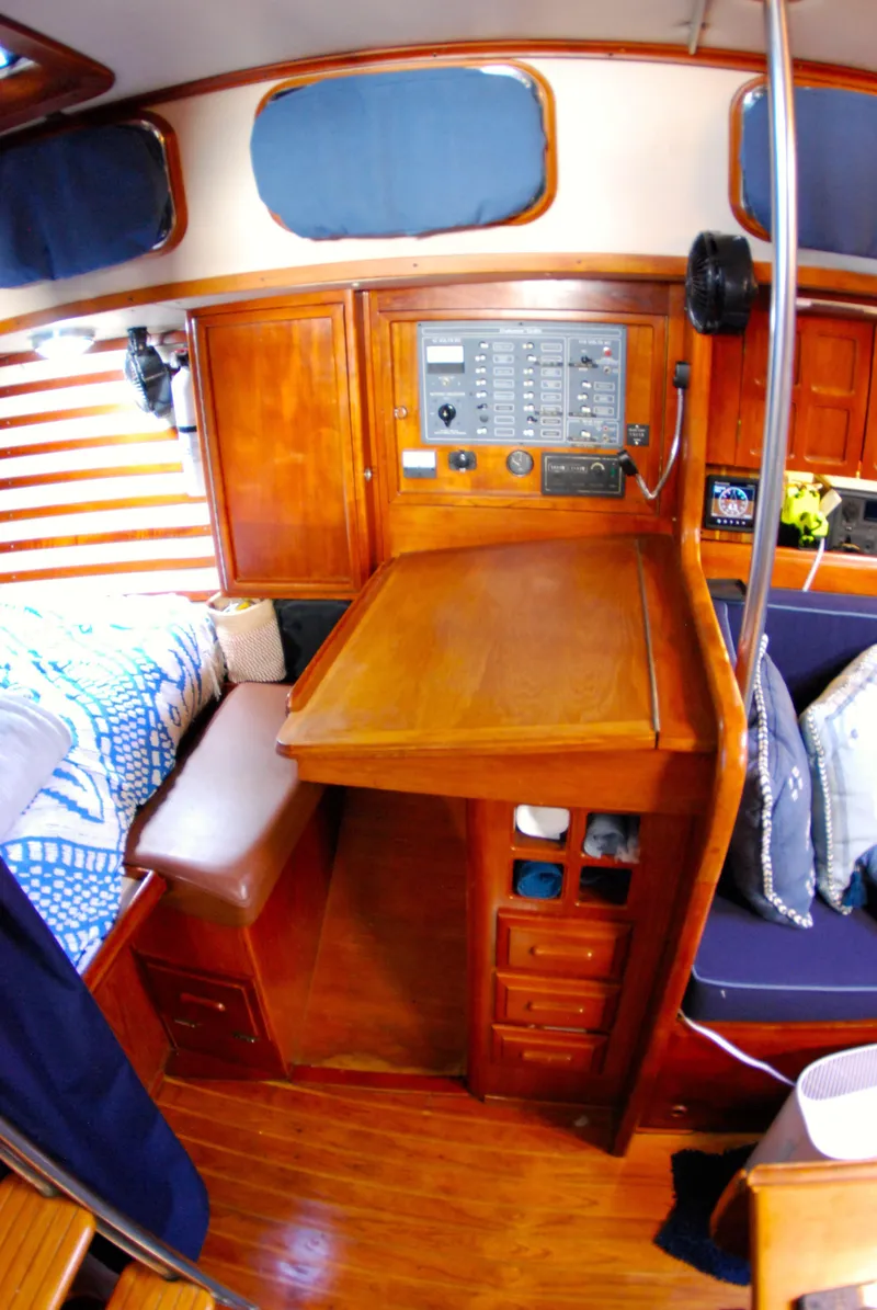 Slide: The Image of 1985 Endeavour 38 sailboat interior with wooden cabinetry and navigation station. - 45