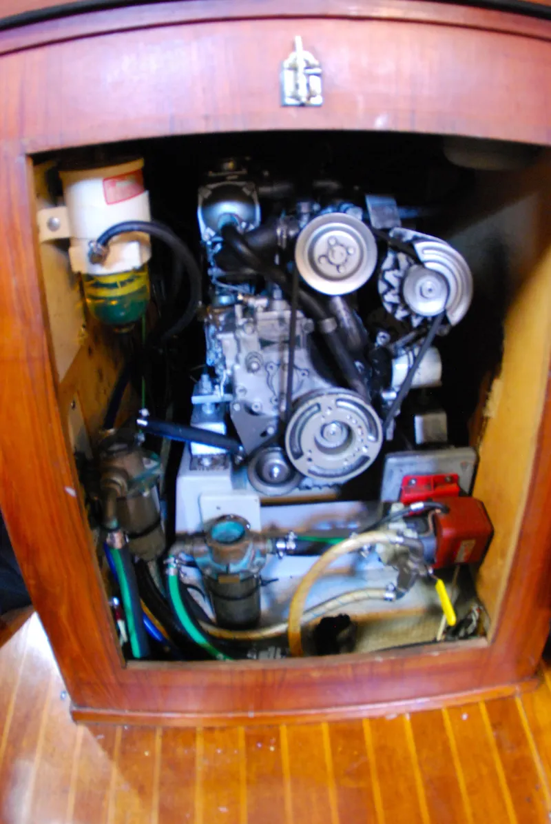 Slide: The Image of Engine compartment of a 1985 Endeavour 38 sailboat, showcasing mechanical components and belts. - 46