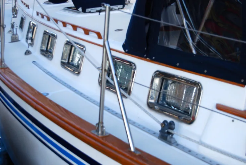 Slide: The Image of 1985 Endeavour 38 sailboat with polished wood trim and stainless steel railings. - 6