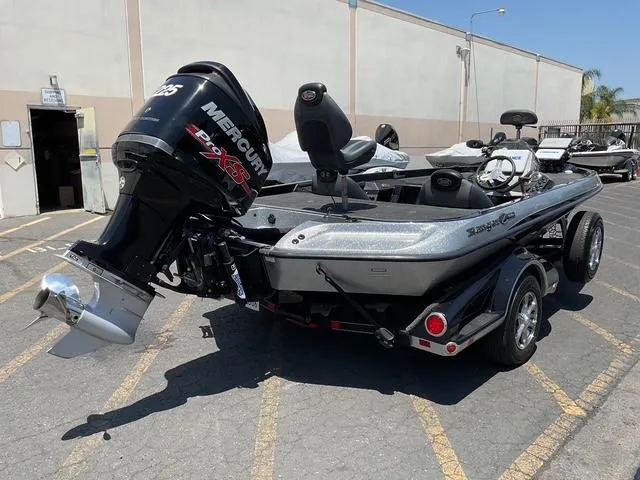 Slide: The Image of 2015 Ranger Z119C Comanche Fusion boat with Mercury Pro XS engine in parking lot. - 2