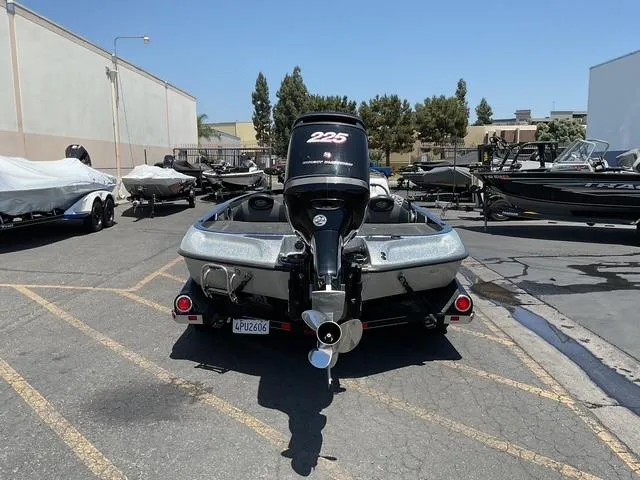 Slide: The Image of 2015 Ranger Z119C Comanche Fusion boat with 225 engine in a parking lot. - 3