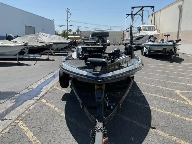 Slide: The Image of 2015 Ranger Z119C Comanche Fusion boat in a parking lot with other boats. - 6