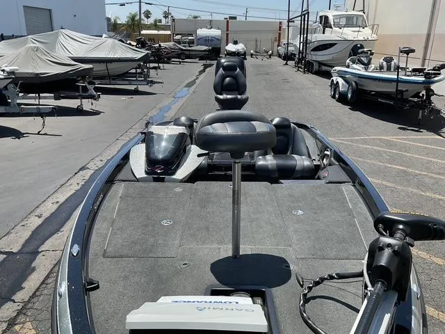 Slide: The Image of 2015 Ranger Z119C Comanche Fusion boat in a marina with other boats. - 8