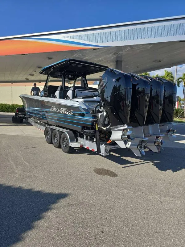 Slide: The Image of 2025 Nor-Tech 400SS boat on trailer with four engines, parked under a canopy. - 9