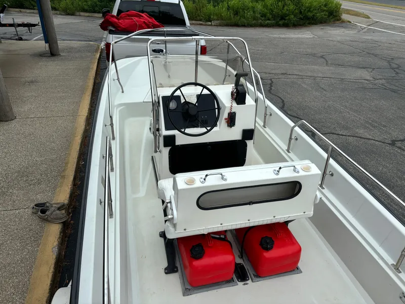 Slide: The Image of 1993 Boston Whaler 17 Montauk boat with steering console and red fuel tanks. - 10