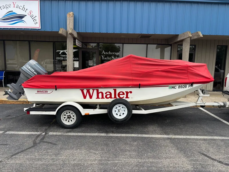 Slide: The Image of 1993 Boston Whaler 17 Montauk boat with red cover on trailer, outside Anchorage Yacht Sales. - 13