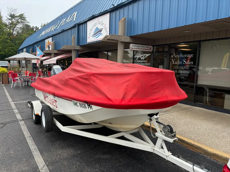Slide: The Image of 1993 Boston Whaler 17 Montauk with red cover on trailer outside Anchorage Yacht Sales. - 14