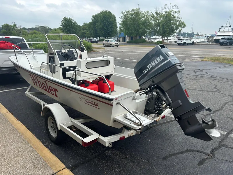 Slide: The Image of 1993 Boston Whaler 17 Montauk boat with Yamaha outboard motor on a trailer in a parking lot. - 4