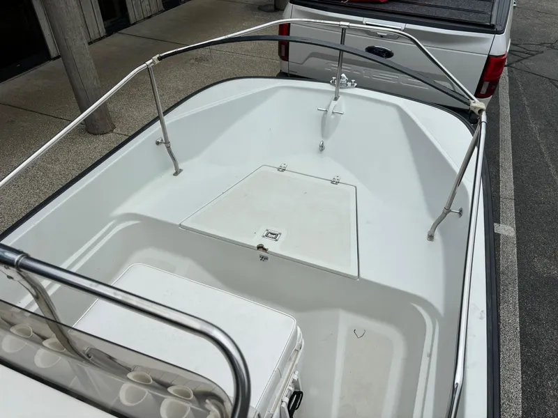 Slide: The Image of 1993 Boston Whaler 17 Montauk boat interior with white deck and railing. - 8