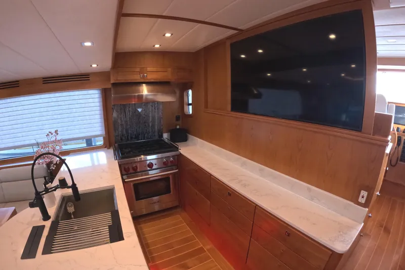 Slide: The Image of Luxurious kitchen interior of 2021 Kadey-Krogen 50 Open yacht with modern appliances and wood finish. - 11
