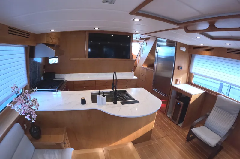 Slide: The Image of Luxurious 2021 Kadey-Krogen 50 Open yacht interior with modern kitchen and elegant wood finishes. - 14