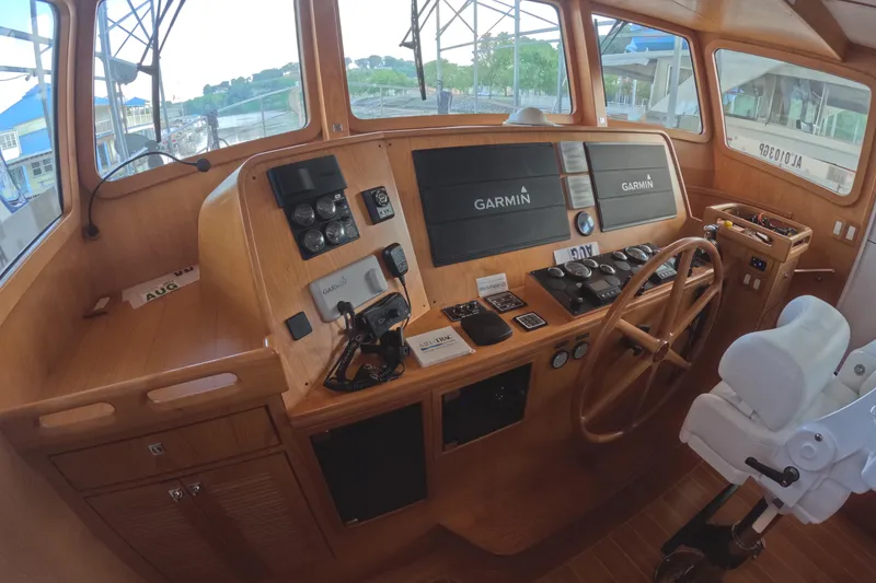 Slide: The Image of Helm of 2021 Kadey-Krogen 50 Open with Garmin navigation system and wooden steering wheel. - 17