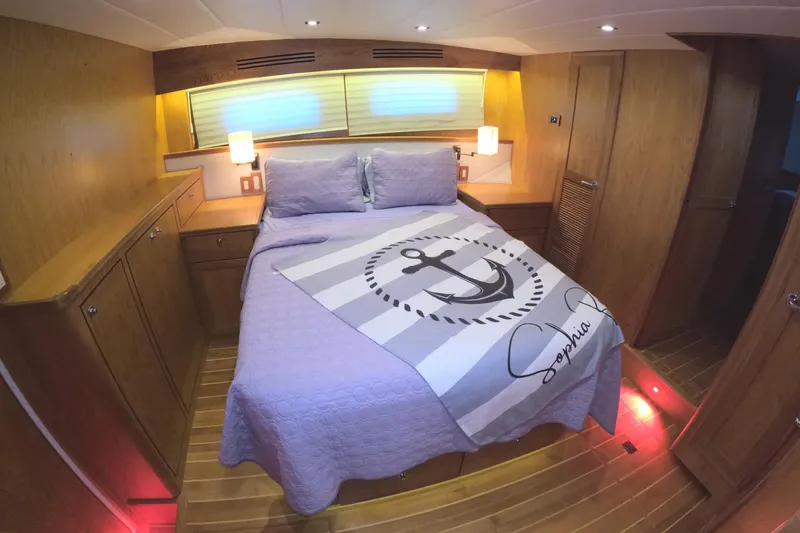 Slide: The Image of Luxurious bedroom interior of 2021 Kadey-Krogen 50 Open yacht with nautical-themed bedding. - 21