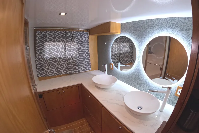 Slide: The Image of Luxurious bathroom in 2021 Kadey-Krogen 50 Open yacht with dual sinks and illuminated mirrors. - 23