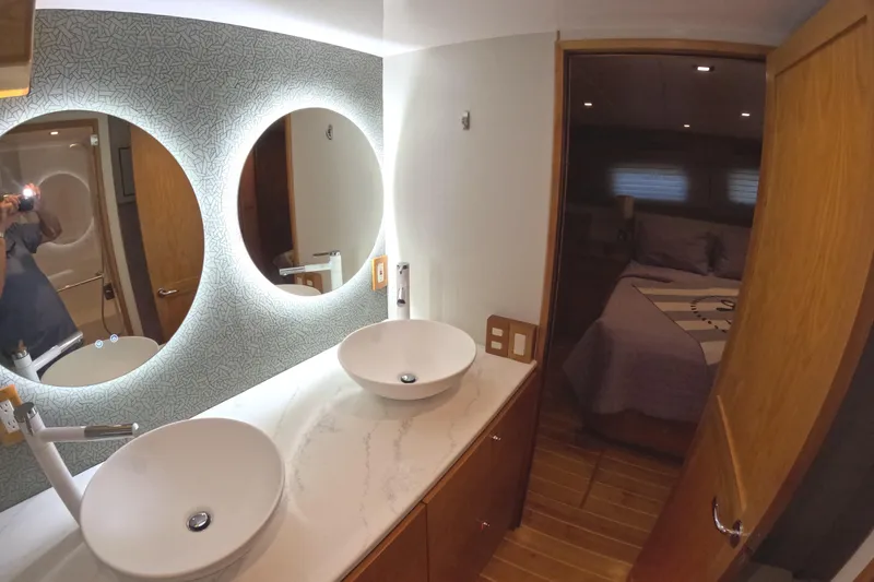 Slide: The Image of Modern bathroom on 2021 Kadey-Krogen 50 Open yacht with dual sinks and illuminated mirrors. - 24