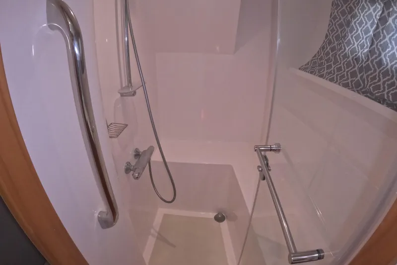 Slide: The Image of Shower area in 2021 Kadey-Krogen 50 Open yacht, featuring modern fixtures and glass door. - 27