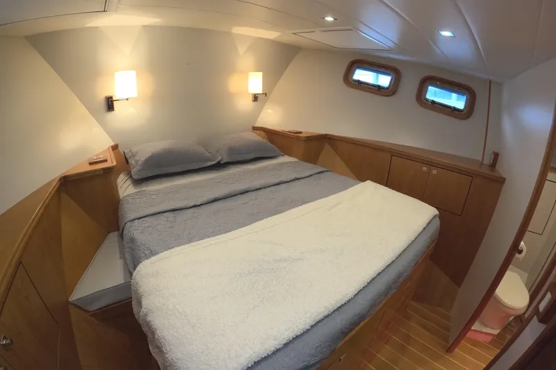 Slide: The Image of Luxurious bedroom interior of 2021 Kadey-Krogen 50 Open yacht with cozy bedding and wooden accents. - 29