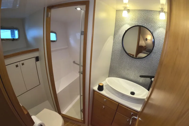 Slide: The Image of Modern bathroom in 2021 Kadey-Krogen 50 Open yacht with stylish fixtures and round mirror. - 31