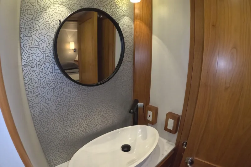 Slide: The Image of Modern bathroom in 2021 Kadey-Krogen 50 Open yacht with round mirror and stylish sink. - 32