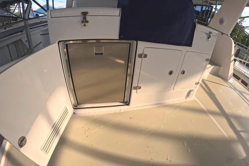 Slide: The Image of Kadey-Krogen 50 Open 2021 yacht deck with storage compartments and stainless steel fridge. - 35