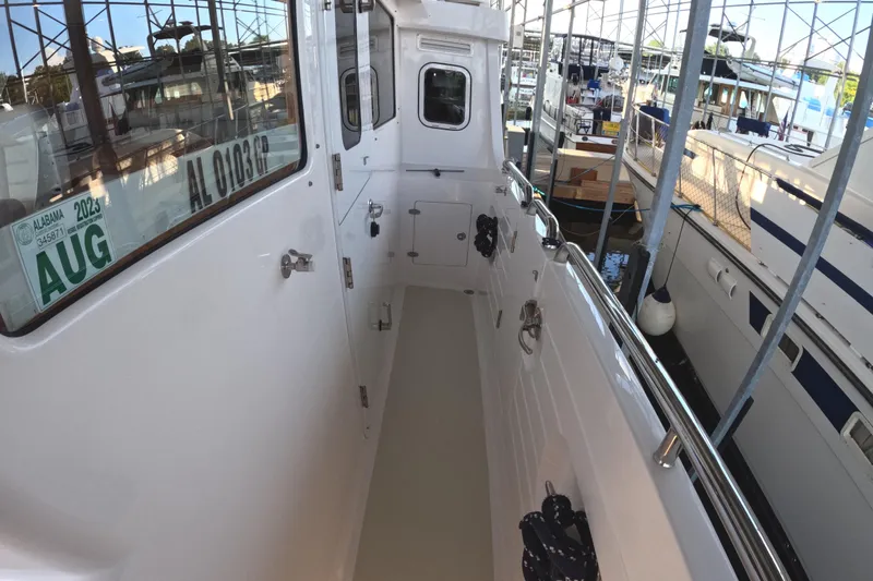 Slide: The Image of Kadey-Krogen 50 Open 2021 yacht docked, featuring sleek white exterior and visible registration. - 39