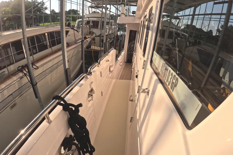 Slide: The Image of 2021 Kadey-Krogen 50 Open yacht docked in marina, side view with reflections. - 40