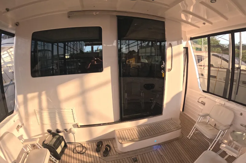 Slide: The Image of 2021 Kadey-Krogen 50 Open yacht interior with seating and large windows. - 42