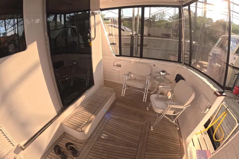Slide: The Image of 2021 Kadey-Krogen 50 Open yacht deck with seating and wooden flooring. - 43