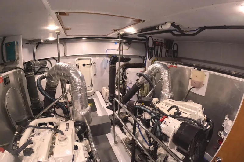 Slide: The Image of Engine room of 2021 Kadey-Krogen 50 Open yacht, featuring dual engines and complex piping. - 49