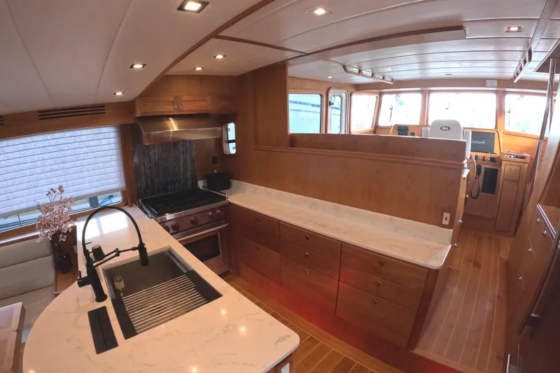 Slide: The Image of Luxurious 2021 Kadey-Krogen 50 Open yacht interior with modern kitchen and helm area. - 6