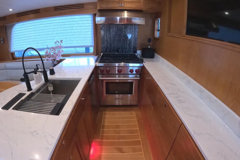 Slide: The Image of Modern kitchen in 2021 Kadey-Krogen 50 Open yacht with sleek countertops and stainless steel appliances. - 7