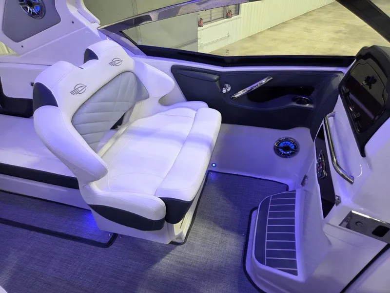 Slide: The Image of 2022 Chaparral 347 SSX boat interior with white seating and modern dashboard. - 10