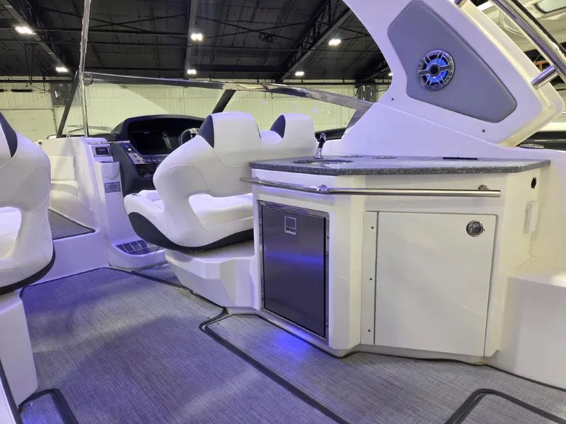 Slide: The Image of 2022 Chaparral 347 SSX boat interior with modern seating and kitchenette area. - 17