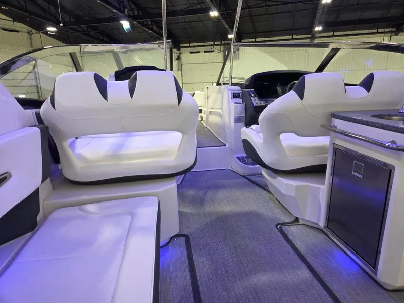 Slide: The Image of 2022 Chaparral 347 SSX boat interior with white seating and modern dashboard. - 18