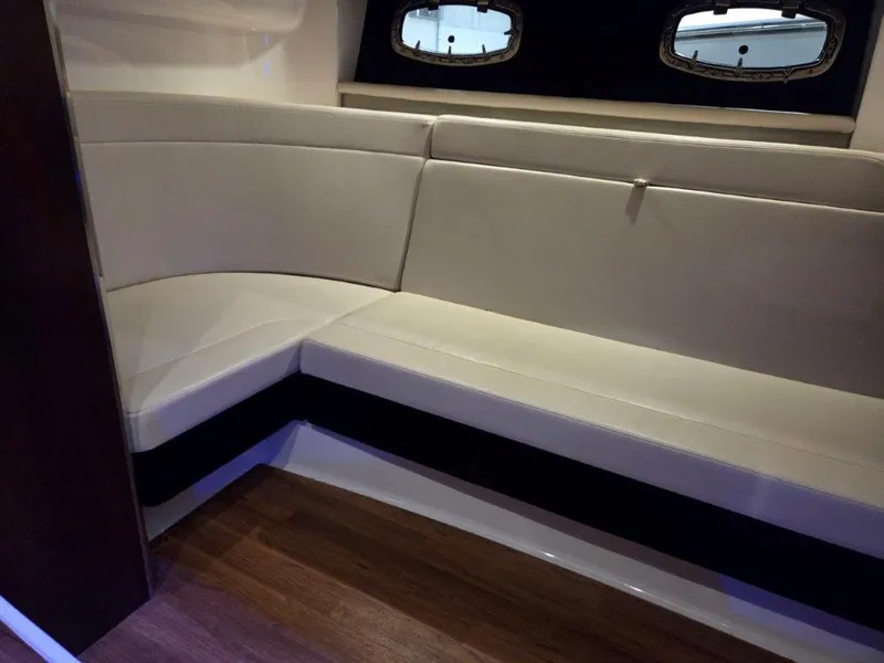 Slide: The Image of Interior seating area of 2022 Chaparral 347 SSX boat with wood flooring. - 23