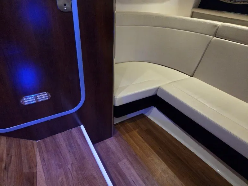 Slide: The Image of 2022 Chaparral 347 SSX interior with wood flooring and white leather seating. - 24