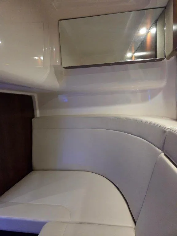 Slide: The Image of Interior cabin of 2022 Chaparral 347 SSX with white seating and mirror. - 27