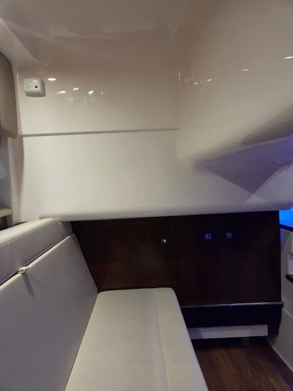Slide: The Image of Interior of 2022 Chaparral 347 SSX boat with white seating and wooden accents. - 29