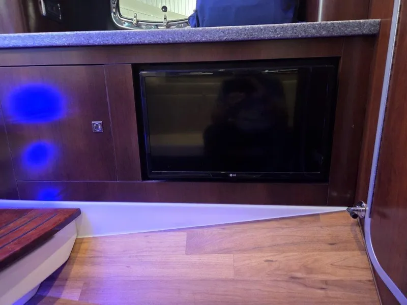 Slide: The Image of 2022 Chaparral 347 SSX interior with built-in LG TV and wood finish. - 30