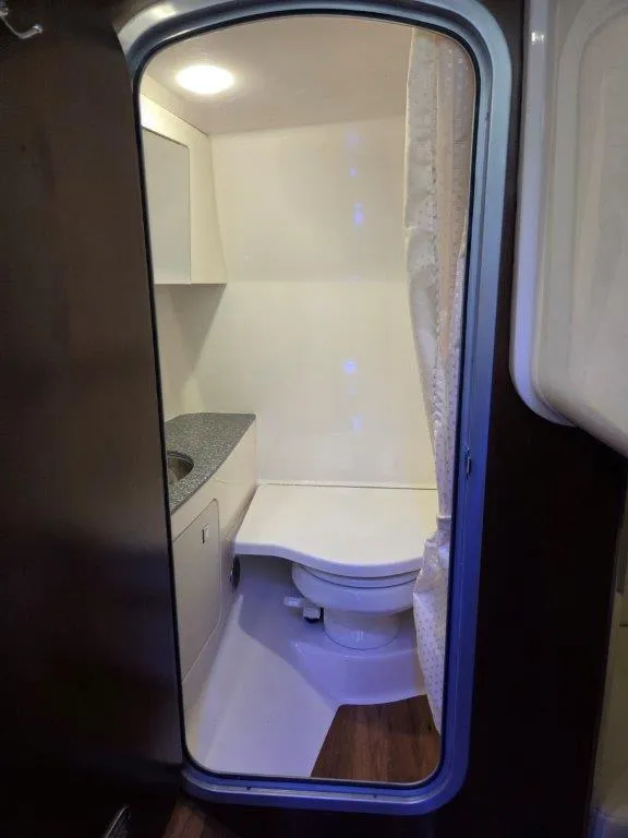 Slide: The Image of 2022 Chaparral 347 SSX boat bathroom interior with toilet and sink. - 31