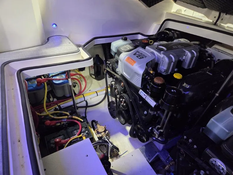 Slide: The Image of Engine compartment of 2022 Chaparral 347 SSX boat, featuring a V8 engine and battery setup. - 38