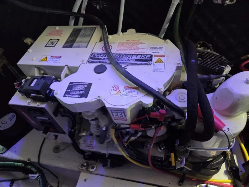 Slide: The Image of Engine compartment of a 2022 Chaparral 347 SSX boat, featuring a Westerbeke generator. - 40